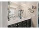 Bathroom featuring double sinks, a large mirror, and dark cabinets at 320 Trout Valley Rd, Wake Forest, NC 27587
