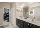 Bathroom featuring double sinks, large mirror, and walk-in closet at 320 Trout Valley Rd, Wake Forest, NC 27587