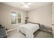 Bright bedroom features a large window with blinds and a ceiling fan at 320 Trout Valley Rd, Wake Forest, NC 27587