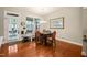 Cozy dining area with hardwood floors, stylish chandelier, and door to a patio at 320 Trout Valley Rd, Wake Forest, NC 27587