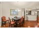 Dining room with hardwood floors, stylish lighting, and access to the kitchen at 320 Trout Valley Rd, Wake Forest, NC 27587