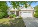 Charming home featuring stone accents, a two-car garage, manicured landscaping, and a welcoming front porch at 320 Trout Valley Rd, Wake Forest, NC 27587