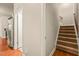Spacious hallway featuring hardwood floors and carpeted stairs at 320 Trout Valley Rd, Wake Forest, NC 27587