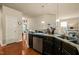 View of kitchen area with granite counters, stainless steel appliances and hardwood floor at 320 Trout Valley Rd, Wake Forest, NC 27587