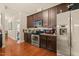 Modern kitchen with stainless steel appliances, dark wood cabinets, and hardwood floors at 320 Trout Valley Rd, Wake Forest, NC 27587