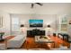 Comfortable living room with hardwood floors, large TV, and neutral-toned furnishings at 320 Trout Valley Rd, Wake Forest, NC 27587