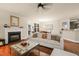 Open living room boasts hardwood floors, a fireplace, and an open layout that seamlessly connects to the dining area at 320 Trout Valley Rd, Wake Forest, NC 27587