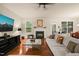 Spacious living room with hardwood floors, fireplace, and plenty of natural light, perfect for relaxing or entertaining guests at 320 Trout Valley Rd, Wake Forest, NC 27587