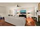 Bright living room featuring hardwood floors, ceiling fan, fireplace and entertainment center at 320 Trout Valley Rd, Wake Forest, NC 27587
