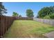 Spacious backyard featuring a well-maintained lawn and a wooden fence for privacy at 34 Schoolhouse Way, Clayton, NC 27520