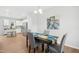Elegant dining room featuring hardwood floors, gray chairs, a dark table, and a modern chandelier at 34 Schoolhouse Way, Clayton, NC 27520