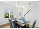 Bright dining area with hardwood floors, stylish gray chairs, a dark table, and ample natural light at 34 Schoolhouse Way, Clayton, NC 27520