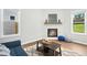 Cozy living room with modern fireplace, hardwood floors, and lots of natural light at 34 Schoolhouse Way, Clayton, NC 27520
