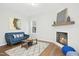 Bright living room with fireplace, plush rug, and comfortable seating arrangement at 34 Schoolhouse Way, Clayton, NC 27520