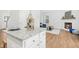 Open-concept living room featuring hardwood floors, fireplace, and a view of the kitchen and dining area at 34 Schoolhouse Way, Clayton, NC 27520