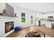 Inviting living room showcasing fireplace and seamless transition to the open-concept kitchen at 34 Schoolhouse Way, Clayton, NC 27520