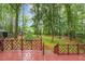 Beautiful backyard featuring a spacious deck, green grass, and a peaceful wooded area at 3420 Greenville Loop Rd, Wake Forest, NC 27587