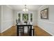 Bright dining room featuring a large bay window, hardwood floors, and elegant lighting fixture at 3420 Greenville Loop Rd, Wake Forest, NC 27587