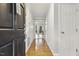 Inviting hallway with gleaming hardwood floors leading to a bright and airy living space at 3420 Greenville Loop Rd, Wake Forest, NC 27587