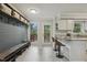 Bright kitchen nook with modern bar seating, stylish fixtures, and an inviting view to the outside deck at 3420 Greenville Loop Rd, Wake Forest, NC 27587