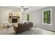 Cozy living room with a classic brick fireplace, large windows, and ample natural light at 3420 Greenville Loop Rd, Wake Forest, NC 27587
