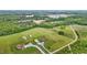 Sprawling rural estate with multiple homes and buildings, surrounded by manicured lawns and natural wooded areas at 3465 Covington Trl, Mebane, NC 27302