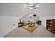 Finished attic features seating area, TV, foosball table, and shelving at 3465 Covington Trl, Mebane, NC 27302