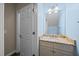 Powder room features granite vanity, decorative mirror, and updated lighting fixtures at 3465 Covington Trl, Mebane, NC 27302
