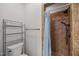 Bathroom features tiled shower with a blue curtain and shelving for storage at 3465 Covington Trl, Mebane, NC 27302