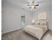 Neutral bedroom with a queen sized bed, ceiling fan, and plenty of natural light at 3465 Covington Trl, Mebane, NC 27302