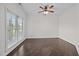 Spacious bedroom features hardwood floors, a ceiling fan, and a large window for ample natural light at 3465 Covington Trl, Mebane, NC 27302