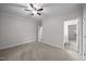 Empty bedroom with neutral walls features ceiling fan and access to the bathroom at 3465 Covington Trl, Mebane, NC 27302