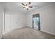 Empty bedroom with neutral walls features ceiling fan, large window and carpeted floors at 3465 Covington Trl, Mebane, NC 27302
