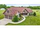 Beautiful one-story home with a manicured lawn, mature landscaping and three car garage at 3465 Covington Trl, Mebane, NC 27302