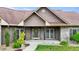 Inviting entrance of this home features stone accents, neutral siding, an covered porch, and manicured landscaping at 3465 Covington Trl, Mebane, NC 27302