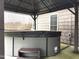 Outdoor hot tub with cover and steps, set on a patio with surrounding foliage at 3465 Covington Trl, Mebane, NC 27302