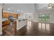 The open kitchen is complemented by views of the hardwood floors and the light-filled living room at 3465 Covington Trl, Mebane, NC 27302