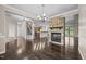 Open-concept living area with stone fireplace, hardwood flooring, and seamless flow into the kitchen at 3465 Covington Trl, Mebane, NC 27302