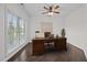Bright home office with a large window, ceiling fan, and a wood desk, ideal for a productive workspace at 3465 Covington Trl, Mebane, NC 27302