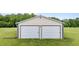 Large two-door outbuilding offers ample storage or workspace on a well-maintained lawn at 3465 Covington Trl, Mebane, NC 27302