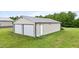 Two-bay garage with side door and a grassy area adjacent to it at 3465 Covington Trl, Mebane, NC 27302
