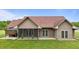 Back of the property features a screen porch, exterior siding and windows, and well-maintained lawn at 3465 Covington Trl, Mebane, NC 27302