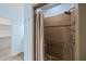 Shower features pebble stone floor and decorative brown tile with handheld sprayer at 3465 Covington Trl, Mebane, NC 27302