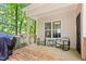 Inviting back porch featuring rocking chairs, a small table, and natural light with views of the backyard at 347 Manchester Trl, Clayton, NC 27527