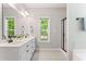 Bright bathroom with dual sinks, modern fixtures, and a window offering natural light at 347 Manchester Trl, Clayton, NC 27527