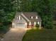 Charming home featuring a manicured lawn, two-car garage, and inviting brick-lined front porch at 347 Manchester Trl, Clayton, NC 27527