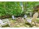 Relaxing backyard fire pit area surrounded by chairs and lush greenery, perfect for outdoor gatherings at 347 Manchester Trl, Clayton, NC 27527