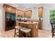 This kitchen offers wooden cabinets, stainless steel appliances, and a central island with seating at 347 Manchester Trl, Clayton, NC 27527