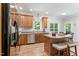 This kitchen offers wooden cabinets, stainless steel appliances, and a central island with seating at 347 Manchester Trl, Clayton, NC 27527