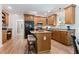 This kitchen offers wooden cabinets, stainless steel appliances, and a central island with seating at 347 Manchester Trl, Clayton, NC 27527